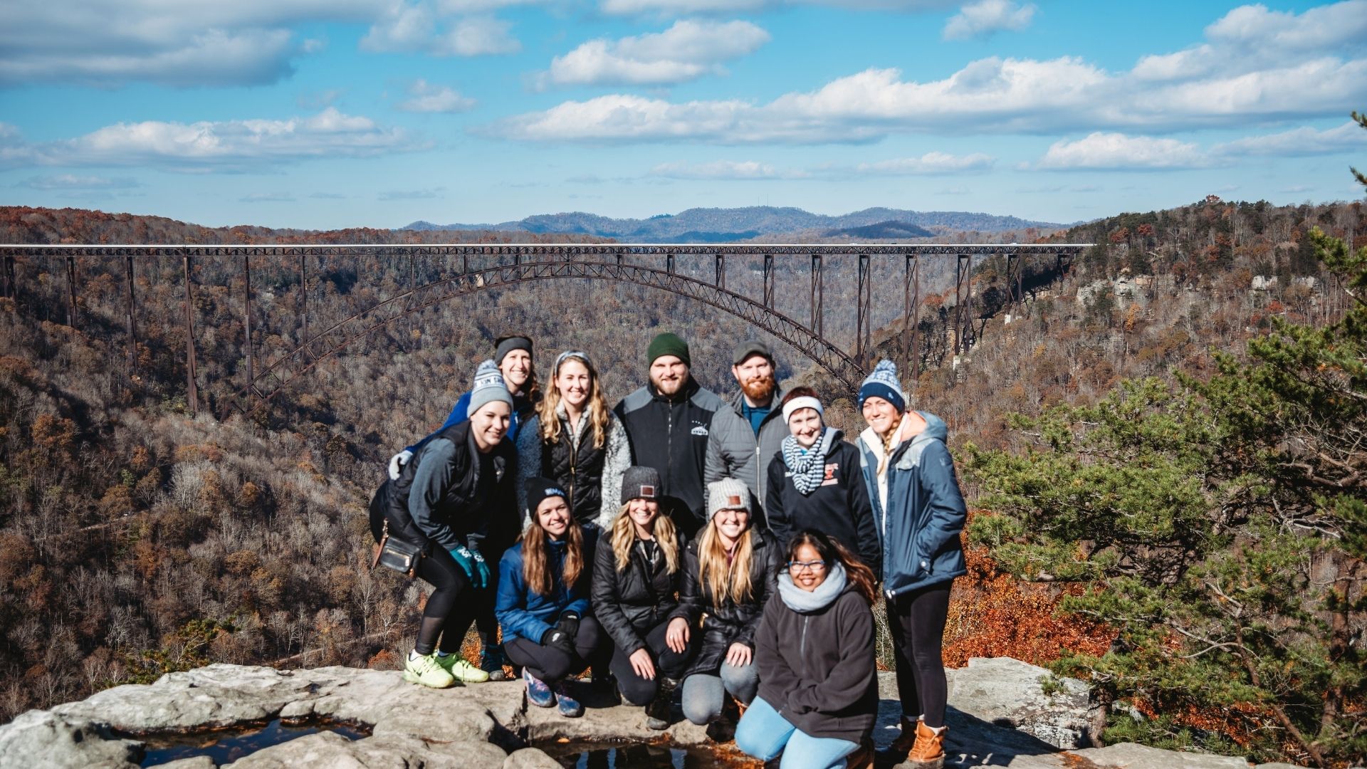 Cohort two fellows group photo in front of the New River Gorge bridge